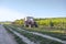 Tractor in vineyards on summer day with blue sky