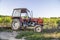 Tractor in vineyards on summer day with blue sky