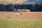 Tractor working on the farm, a modern agricultural transport, a farmer working in the field, fertile land, tractor on a sunset