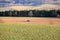 Tractor working on the farm, a modern agricultural transport, a farmer working in the field, fertile land, tractor on a sunset