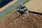 Tractor working on a field with many sea gulls in the Salzkammergut, Austria, Europe