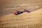 Tractor Working in the Fields, Aerial View. Hay on the field. The view from the top. Tractor harvests dry grass