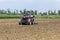 A tractor working planting wheat in the fertile farm fields of G