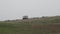 Tractor working during rain storm at Lenan Head in County Donegal, Ireland