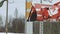 a tractor with a yellow bucket removes snow from the street in winter. Road cleaning assistance, industry