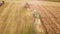 tractors and combines work.summer agricultural fields during harvest.