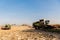 Tractors harvesting wheat field against blue