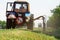 Tractors machines mowing lawn grass along road