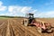 Tractors Plowing Field