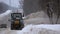 Tractors of road service clean up the snow from the roadside