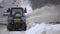 Tractors of road service clean up the snow from the roadside