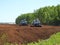 Tractors working in marsh