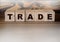 Trade word on Wooden cubes on red. Business deals Concept