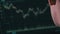 Trader Analyzes Cryptocurrency Charts on a Laptop Screen in the Dark