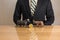 Trader sitting in front of wooden desk