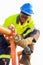 Tradesman working with an angle grinder on a building site