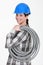 Tradeswoman carrying corrugated tubing