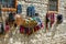 Tradional Azerbaijani souveniers hats and knitted clothing sold in Huseynov street, view on cobblestone, the main street of Lahic