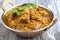 Traditinal Indian Lamb Curry offered in a rustic Korai