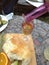 Tradition, Serbian sliced bread under the name pogaca, with orange fruit, sliced avocado bottle of white wine and rosemary