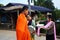 Tradition thai of almsgiving thai monks procession walk on the street for thai people respect praying and put food offerings in