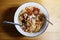 Tradition Thai food Hot and spicy Seafood instant noodle in white bowl with fork and spoon on wooden floor background