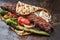 Traditional adana kebap on a skewer with tomato and yogurt on a flatbread
