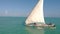 Traditional Africal Sailboat at Zanzibar island Paje beach in blue Indian ocean aerial view. Unguja, tanzania