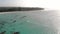 Traditional Africal Sailboats at Zanzibar Kendwa beach at evening time with blue Indian ocean aerial view