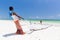 Traditional african local rural fishing on Paje beach, Zanzibar, Tanzania. Traditionally dressed local woman pulling