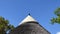 A Traditional African Thatch and Mud Rondavel, Kruger Park safari. Blue sky