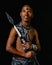 Traditional African Xhosa prince holding a traditional beaded handmade spear.