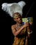 Traditional African Xhosa prince listens to a handmade wire radio.
