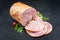 Traditional Allgauer veal roast roll sausage sliced and as piece with tomatoes and chili