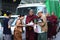 Traditional Alms giving ceremony of distributing food to buddhist monks on the streets of Yangon , Myanmar