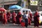 Traditional Alms giving ceremony of distributing food to buddhist monks on the streets of Yangon , Myanmar