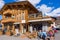 Traditional Alpine house, restaurant with tourists relaxing, Livigno, Alps