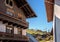 Traditional alpine houses with balconies. The windows are decorated. Fragment. In the background, the cable car. Austria