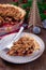 Traditional American apple cranberry pie, topped with crumbled dough and pecan, vertical