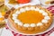 Traditional American pumpkin pie with whipped cream. Thanksgiving cake.