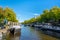 Traditional Amsterdam canal with boats houseboats and bridges