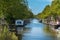 Traditional Amsterdam canal with boats houseboats and bridges