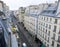 Traditional apartment buildings, typical facades old parisian house with french balconies and flowerpots. Paris France