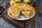 Traditional apple jalousie cake in a backing form on an old rustic wooden board