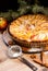 Traditional apple pie and Christmas tree branches