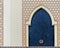 Traditional arabesque pattern on the wall, arched iron door with decorative ornament