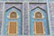 Traditional Arabic mashrabiya window on a tiled wall enclosed with carved wood latticework
