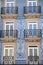 Traditional architecture of buildings with tiles in Porto Portugal. Blue facades with windows and balcony
