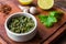 Traditional Argentinian chimichurri sauce against wooden background.