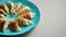 Traditional asian dumplings Gyozas on turqoise ceramic plate